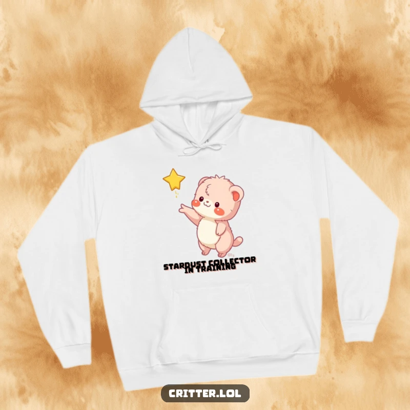 Funny hoodie features a fuzzy creature reaching for a falling star, offering warmth and a humorous, aspirational message for screen readers.