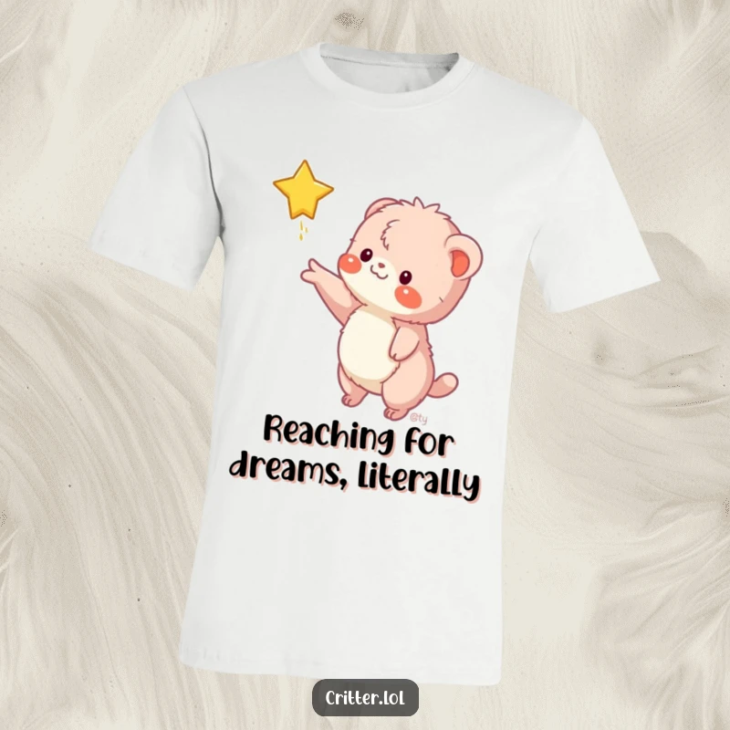 Funny t-shirt depicts a fuzzy creature stretching an arm to catch a falling star, symbolizing ambition and cosmic dreams with humor.